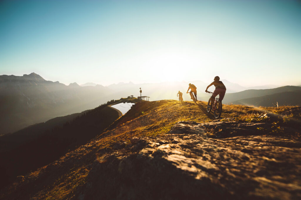 Home 1 Mountainbiker in der Abendsonne über den Bergen